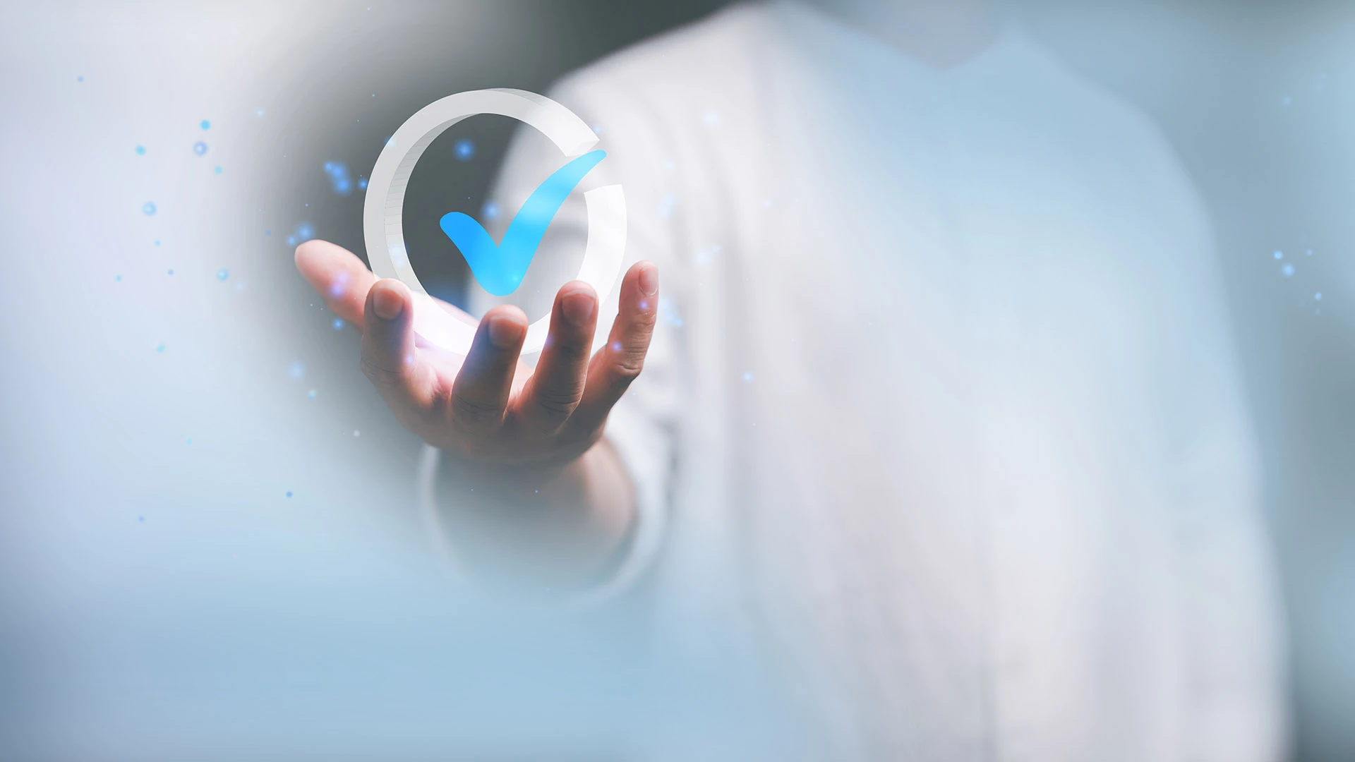 Digital confirmation checkmark in hand in front of blurred background, concept for success and approval in the technology industry. ©shutterstock