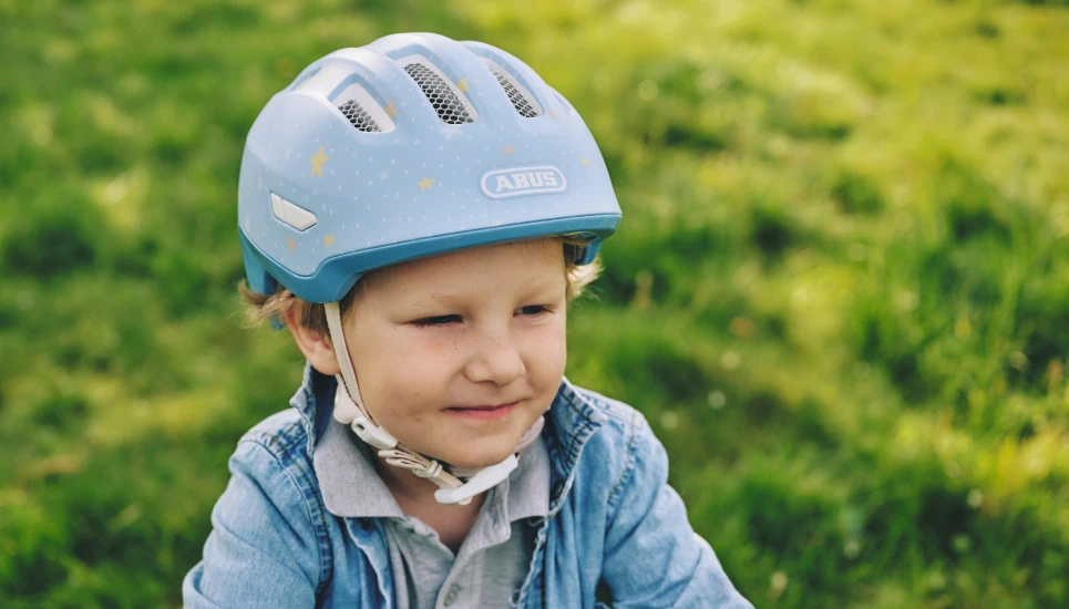 Nahaufnahme eines Jungen mit dem Kinderhelm Smiley 3.0 FL.ACE LED pure bluestars © ABUS