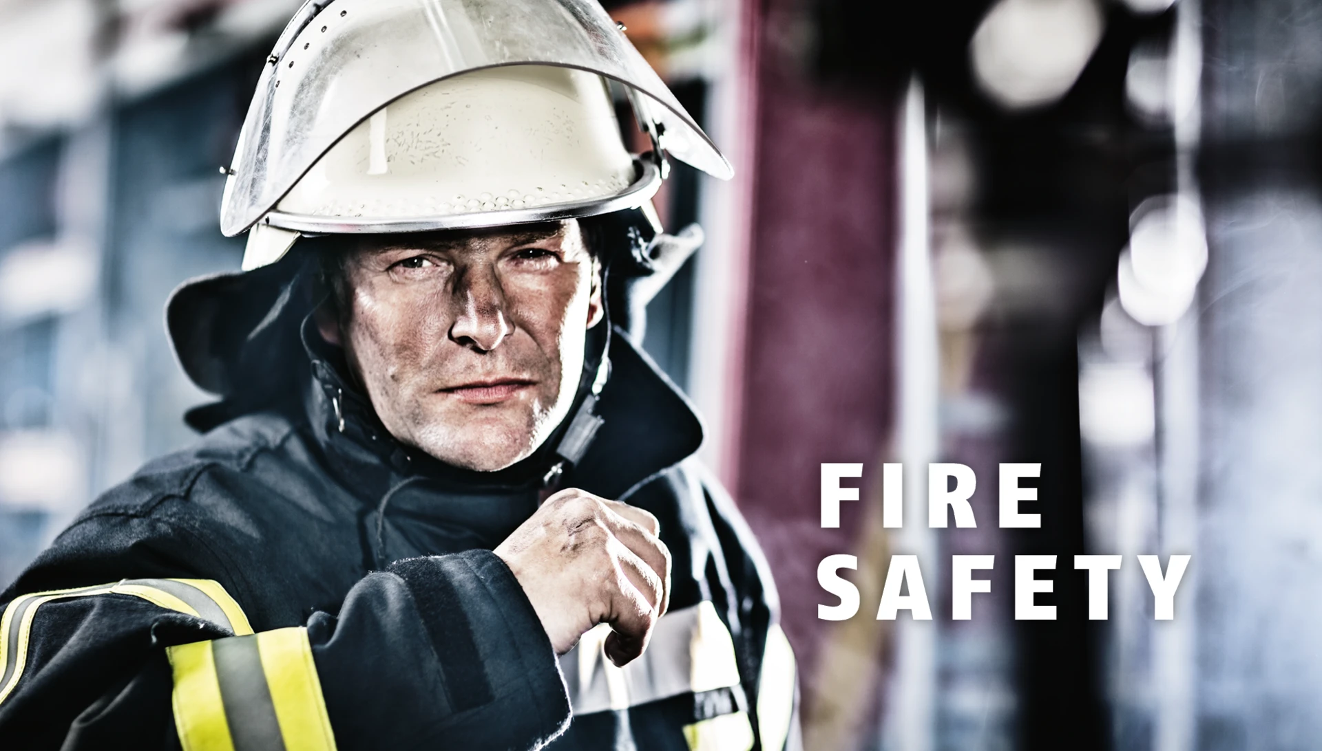 Portrait of a firefighter in protective gear and helmet © ABUS
