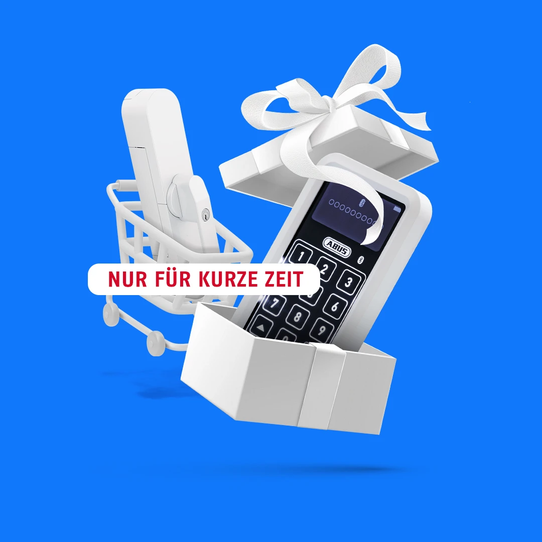 WINTECTO in einem Einkaufswagen und davor eine geöffnete Geschenkbox, in der eine Tastatur ist © ABUS