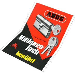 Un cartel negro y rojo que muestra un cilindro para puerta ABUS con llaves, con la inscripción "Probados millones de veces" © ABUS