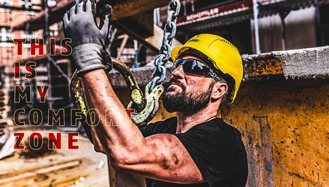 Man working on construction site with Scator hard hat and safety goggles © ABUS