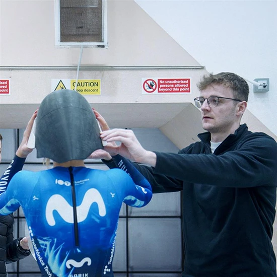 product developer Lennart Bechheim testing new aerodynamic prototype of the TT helmet TimeShifter on a Movistar pro athlete in a wind tunnel © ABUS