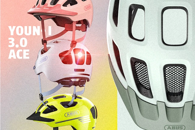 Youn-I 3.0 ACE bicycle helmets in pink, gray, and neon yellow with a built-in taillight © ABUS
